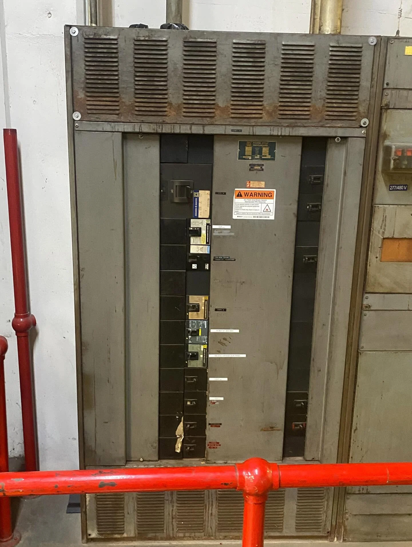 Licensed electrician installing a 200A main service panel with clean EMT conduit in Downey, CA